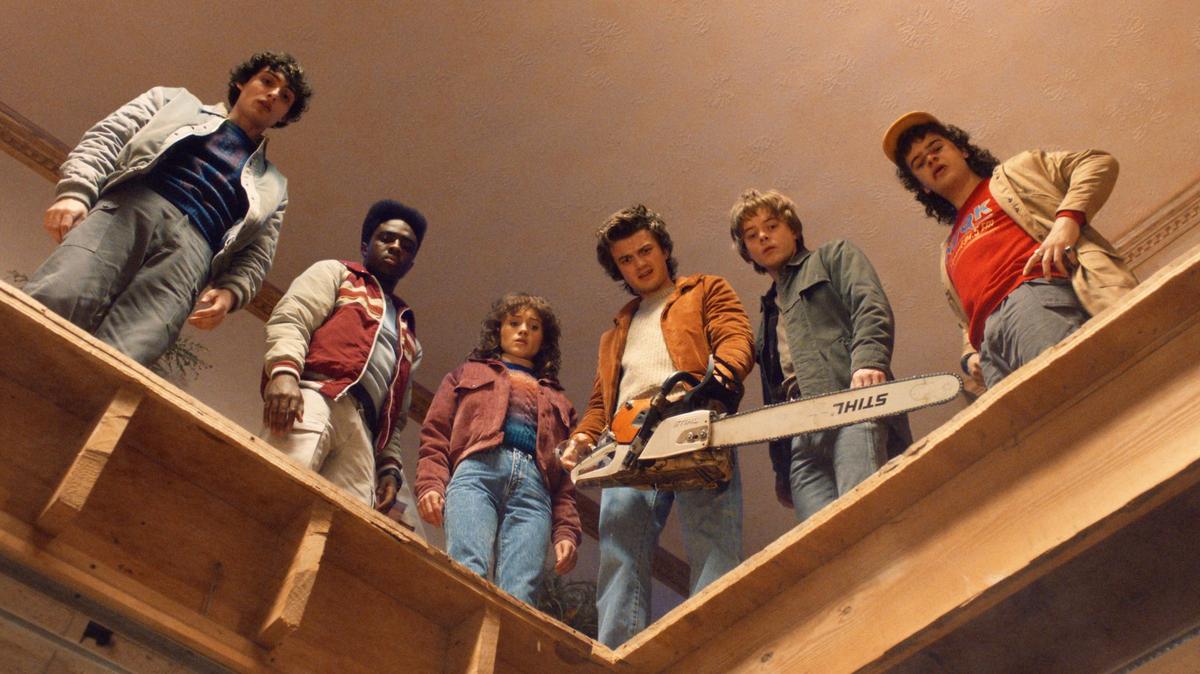 Finn Wolfhard, Caleb McLaughlin, Natalia Dyer, Joe Keery, Charlie Heaton and Gaten Matarazzo in Stranger Things Season 5. 