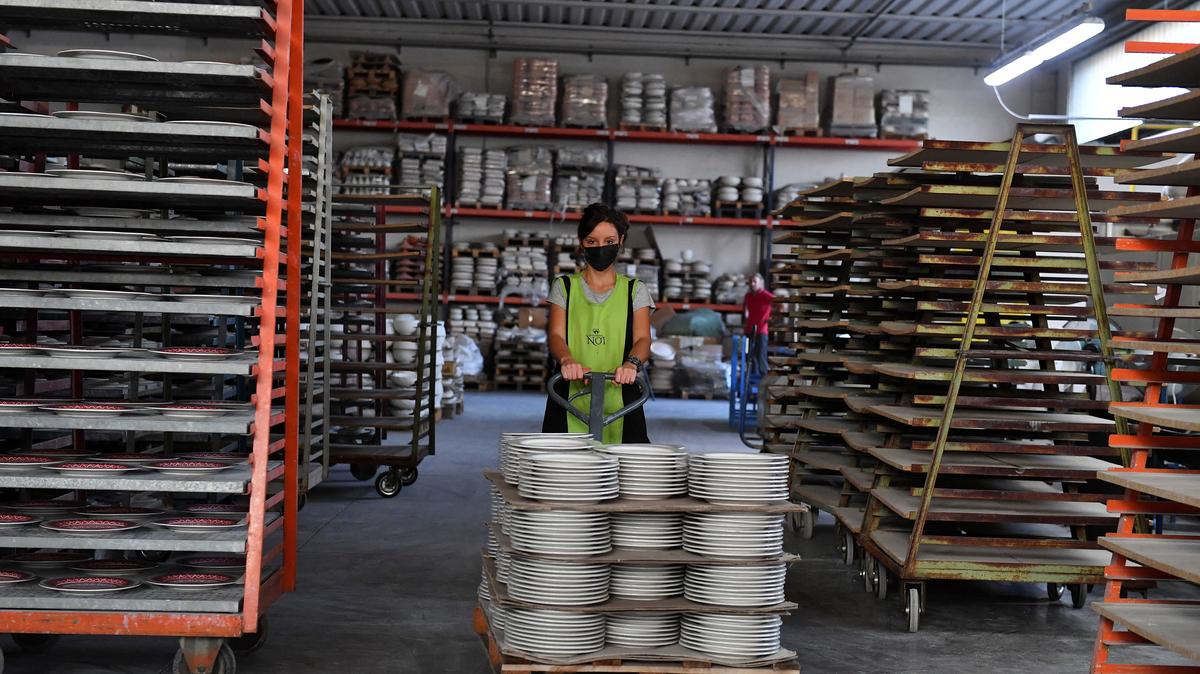 An employee works at a ceramics factory where the workers start their shifts before dawn to optimise sunlight and save energy, in Citta di Castello, Italy, August 30, 2022. REUTERS/Jennifer Lorenzini