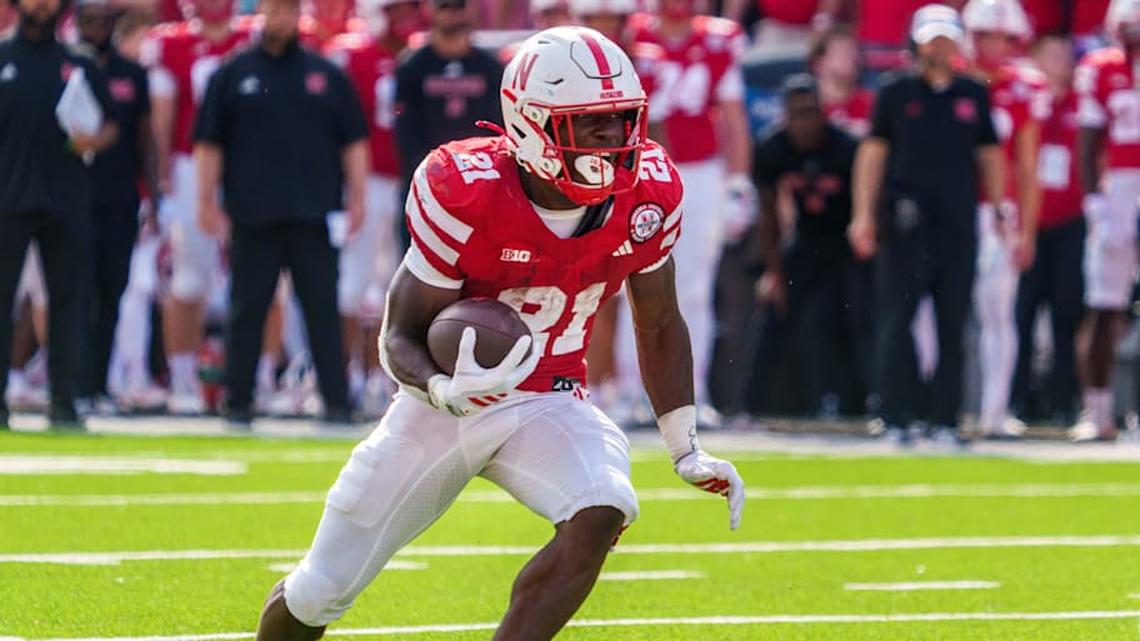  Sep 20, 2025; Lincoln, Nebraska, USA; Nebraska Cornhuskers running back Emmett Johnson (21) runs against the Michigan Wolverines during the second quarter at Memorial Stadium. Mandatory Credit: Dylan Widger-Imagn Images | Dylan Widger-Imagn Images 