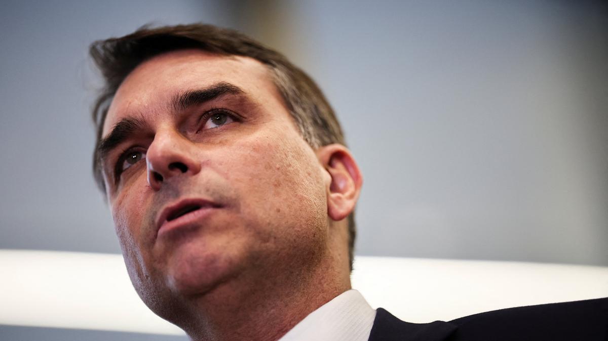 Flavio Bolsonaro speaks with members of the press after a meeting, following a scandal over messages tied to his request for funding for a biopic about former Brazilian President Jair Bolsonaro, from disgraced banker Daniel Vorcaro, who was arrested in March on suspicion of leading a multibillion-dollar fraud scheme, in Brasilia, Brazil, May 19, 2026. REUTERS/Mateus Bonomi