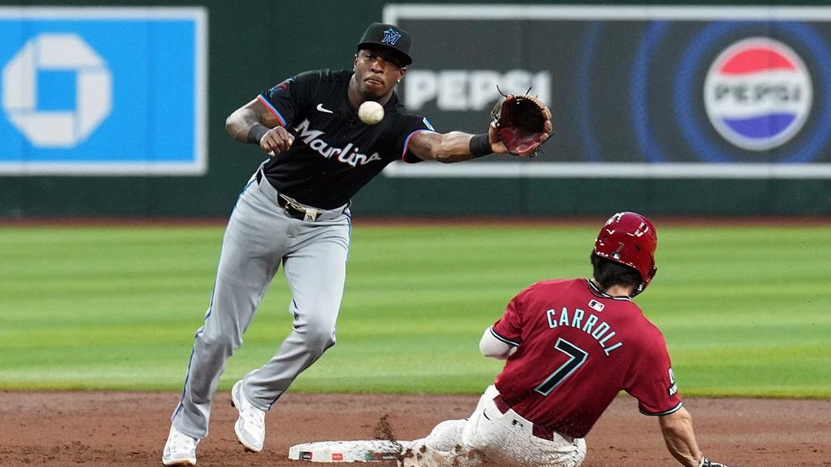 May 25, 2024; Phoenix, Arizona, USA; Arizona Diamondbacks outfielder Corbin Carroll (7) beats a throw to Miami Marlins shortstop Tim Anderson (7) to steal second base during the first inning at Chase Field.
