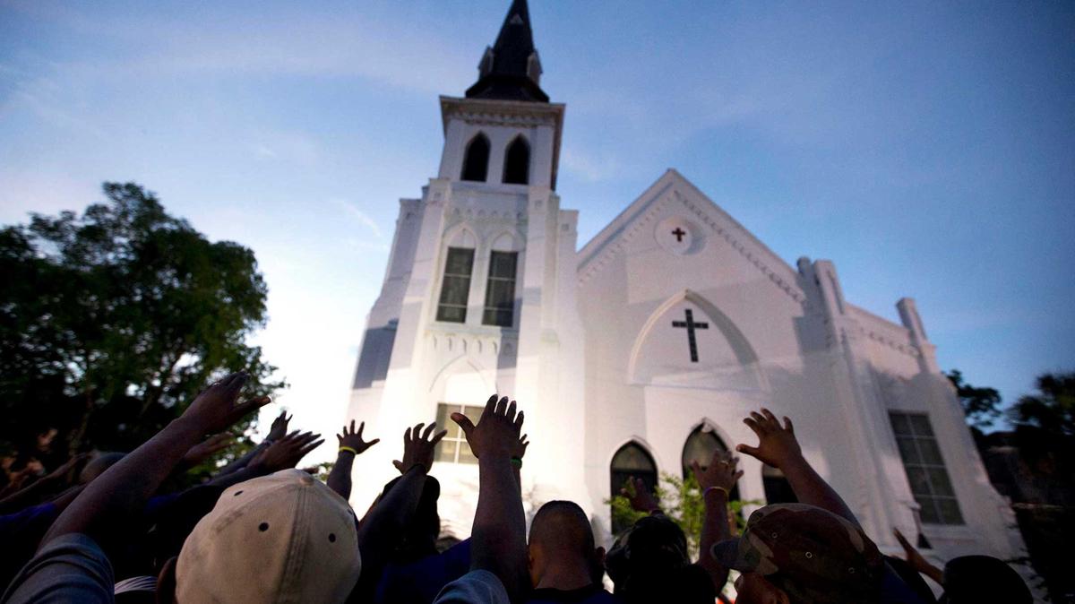 A crowd prays outside the Emanuel AME Church after a memorial service for the nine people killed in a racist attack at the church in Charleston, S.C., June 19, 2015.Stephen B. Morton-AP