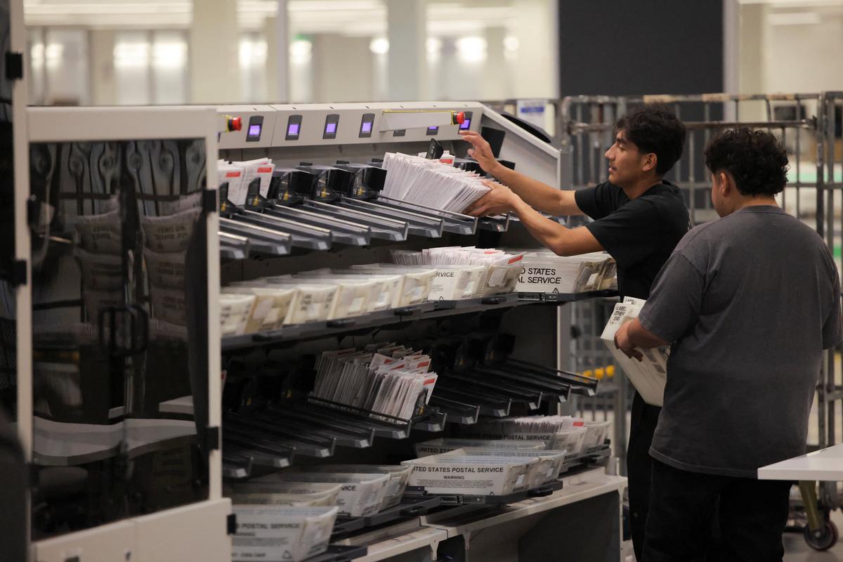 Election workers process ballots during the California primary election at the Los Angeles County Ballot Processing Center in City of Industry, California, on Tuesday.