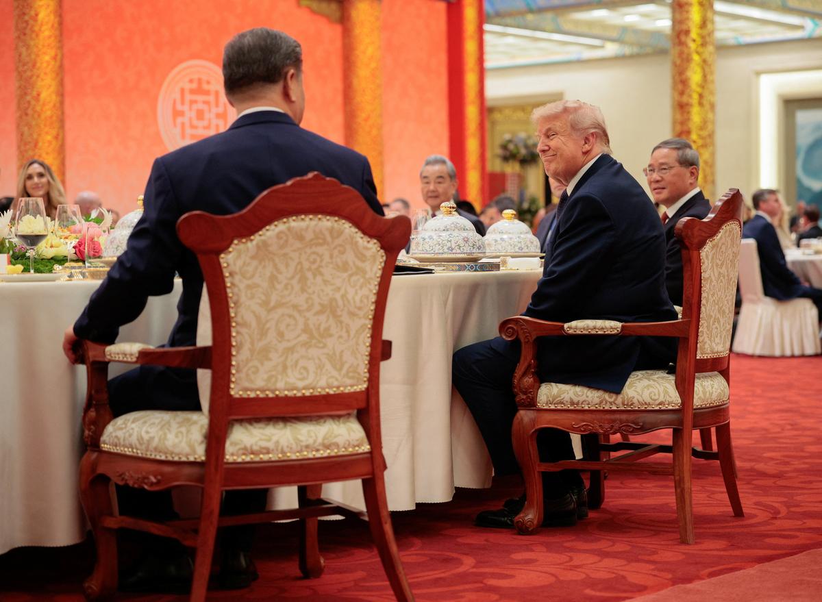 U.S. President Donald Trump reacts next to Chinese President Xi Jinping at a state banquet at the Great Hall of the People in Beijing, China, May 14, 2026. REUTERS/Evan Vucci