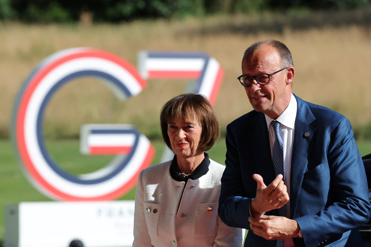 Germany's Chancellor Friedrich Merz and his wife, Charlotte Merz, arrive at the Hotel Royal to attend the G7 Summit in Evian-les-Bains, France, June 15, 2026. REUTERS/Christian Hartmann/Pool