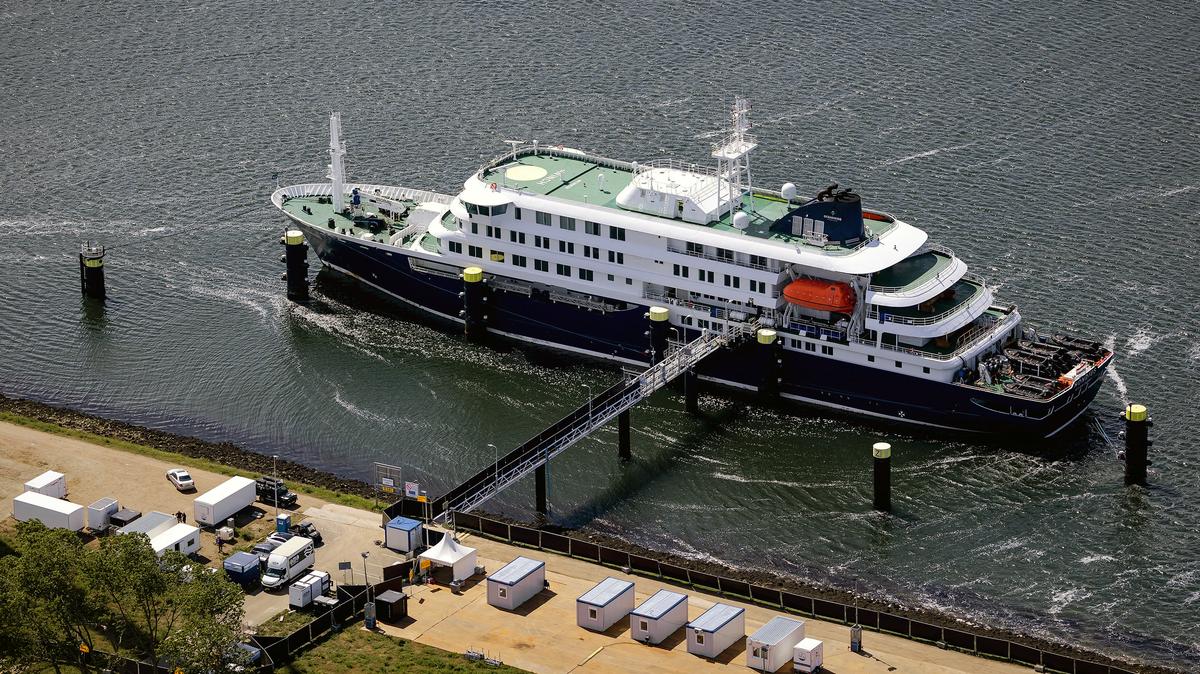 This aerial view shows the Dutch Hantavirus-hit cruise ship MV Hondius docked after arriving at the port of Rotterdam on May 18, 2026. A cruise ship that sparked global alarm after a deadly outbreak of hantavirus docked in Rotterdam harbor on May 18, with the skeleton crew facing weeks of quarantine. (Peter Lipton/ANP/AFP/Getty Images/TNS)