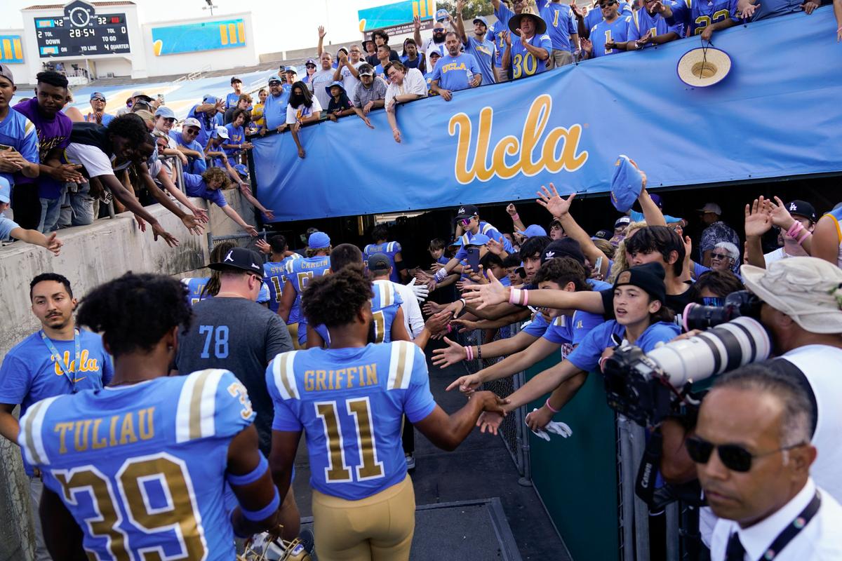 FILE - UCLA football players greet fans as they leave the field after a 42-32 win over Utah in an NCAA college football game in Pasadena, Calif., Saturday, Oct. 8, 2022. UCLA cleared a major hurdle toward joining the Big Ten Conference in 2024, getting approval for the move from the University of California Board of Regents on Wednesday, Dec. 14, 2022. (AP Photo/Ashley Landis, File)