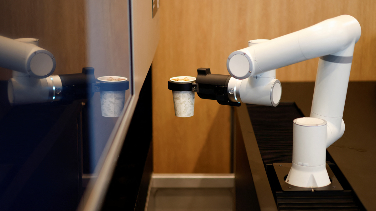 A robot arm prepares coffee at an unmanned cafe in Seoul, South Korea, June 19, 2026. REUTERS/Kim Soo-hyeon