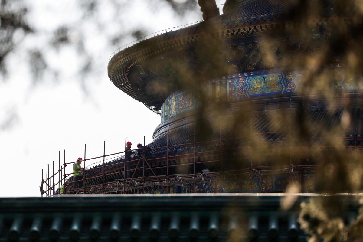 Construction workers work on the scaffolding surrounding the Hall of Prayer for Good Harvests at the Temple of Heaven, or Tiantan Park, ahead of this week’s U.S. President Donald Trump's visit to China, in Beijing, China, May 11, 2026. REUTERS/Maxim Shemetov