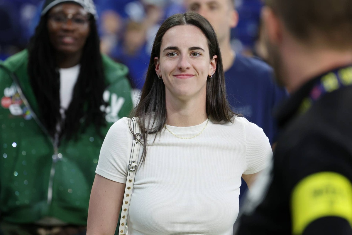  Oct 5, 2025; Indianapolis, Indiana, USA; Caitlin Clark looks on from the sideline during warmups before the game between the Las Vegas Raiders and the Indianapolis Colts at Lucas Oil Stadium. Mandatory Credit: Trevor Ruszkowski-Imagn Images 
