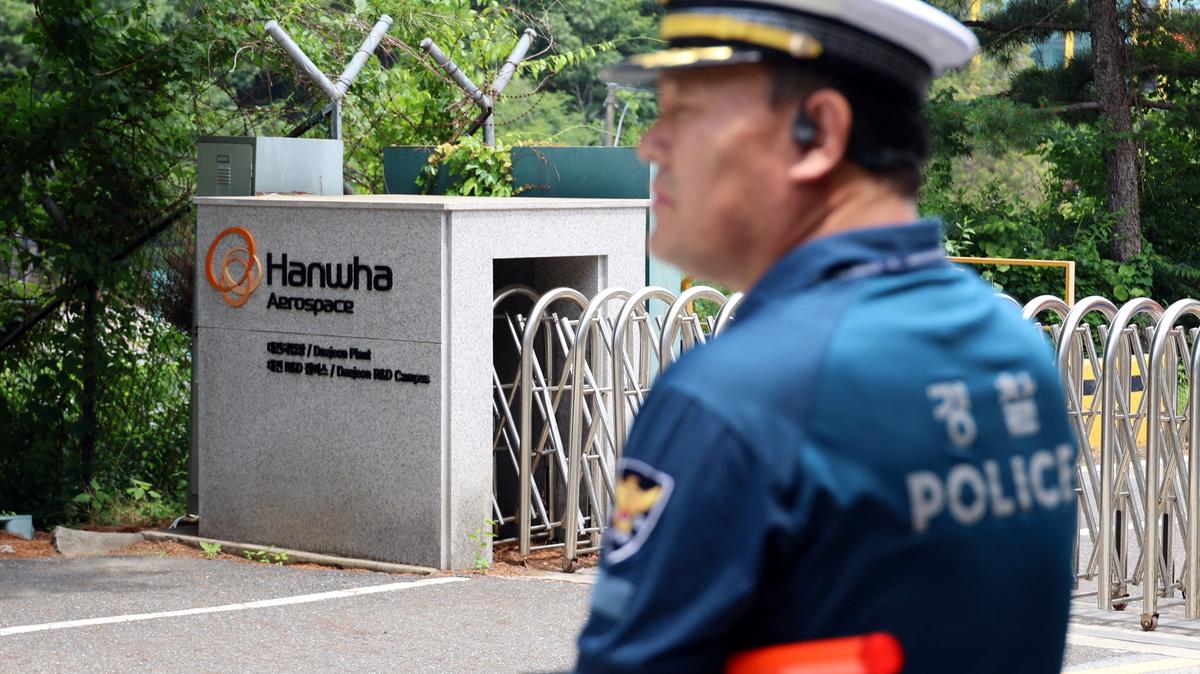 A police officer controls the area in front of the main gate of Hanwha Aerospace’s factory that caught fire after an explosion, in Daejeon, South Korea, June 1, 2026.    Yonhap via REUTERS