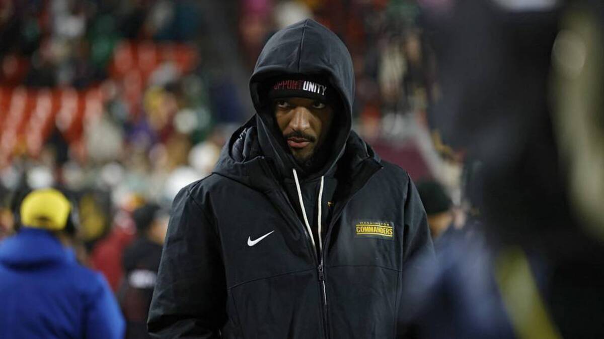  Dec 20, 2025; Landover, Maryland, USA; Washington Commanders quarterback Jayden Daniels (5) looks on from the sidelines during the fourth quarter against the Philadelphia Eagles at Northwest Stadium. | Amber Searls-Imagn Images 