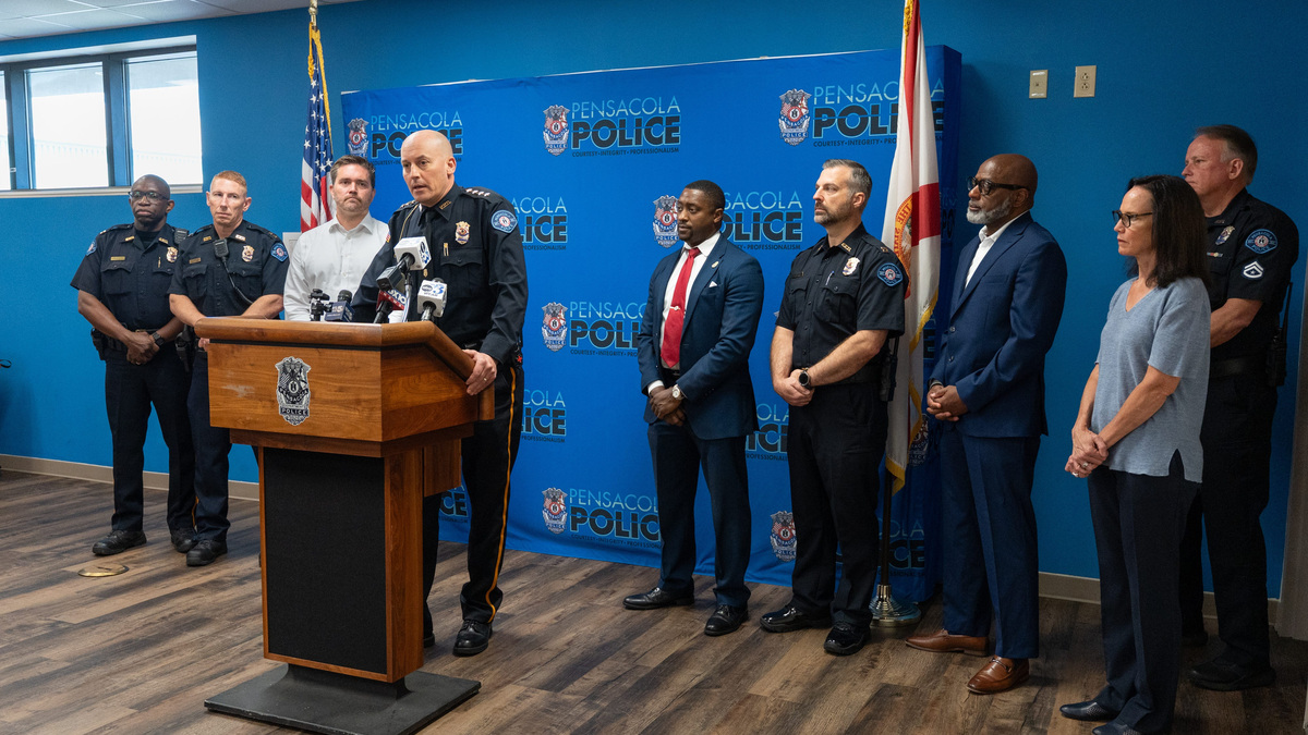 Officials listen as Chief Eric Winstrom, center, gives an update about the fatal shooting on Intendencia Street early on Sunday morning during a press conference at the Pensacola Police Department on July 6, 2026.