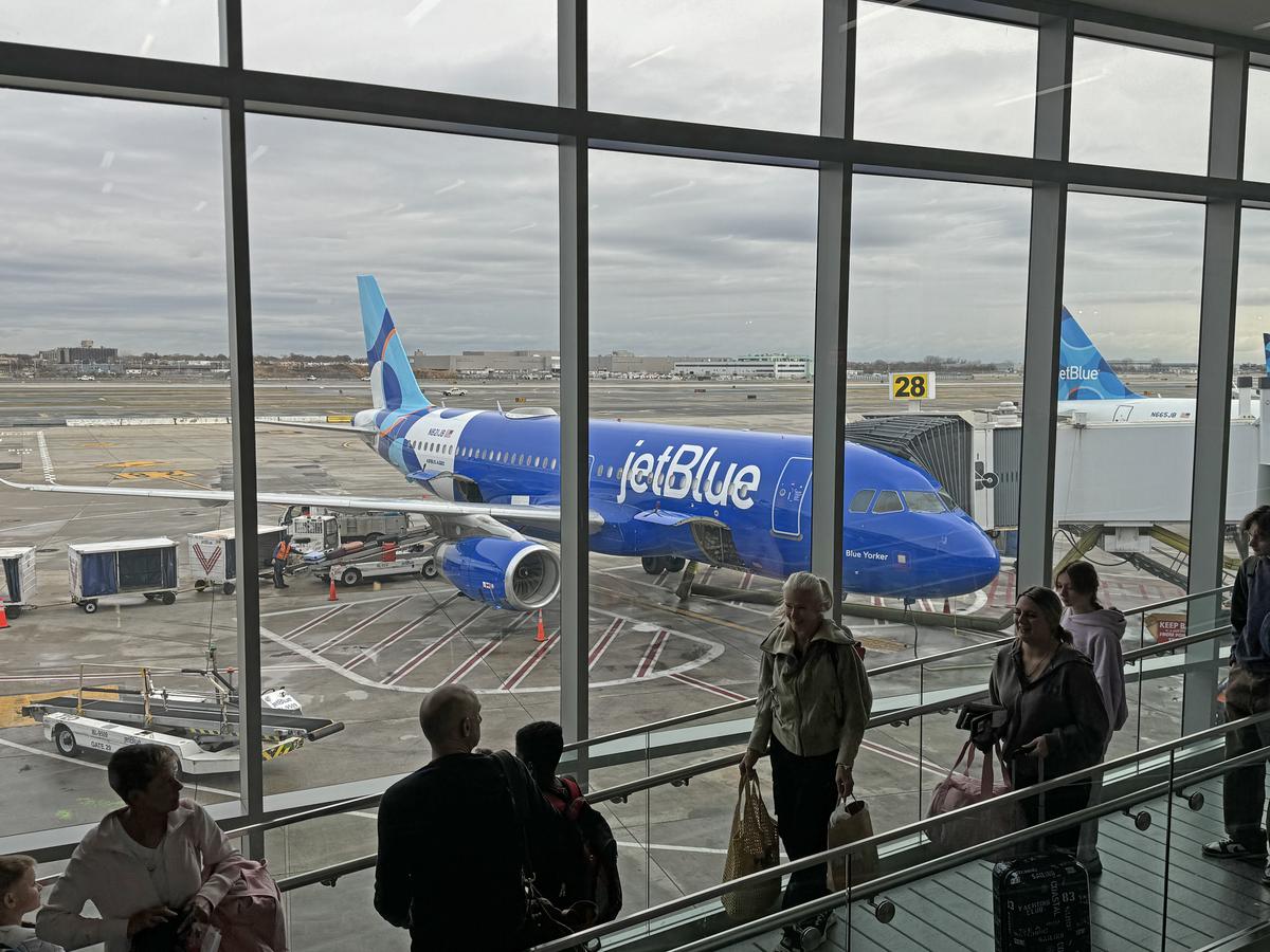  Passengers line up to board a flight at John F. Kennedy International Airport in New York City on November 23, 2024. 