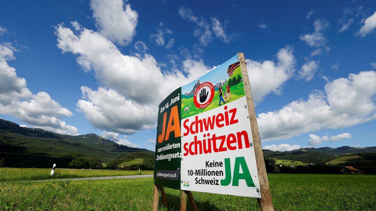 A sign stands in a field between Eichenwies and Eichberg, on the day of the vote on a plan backed by the right-wing Swiss People's Party (SVP) to limit population growth to 10 million inhabitants, Switzerland, June 14, 2026.  REUTERS/Michaela Stache