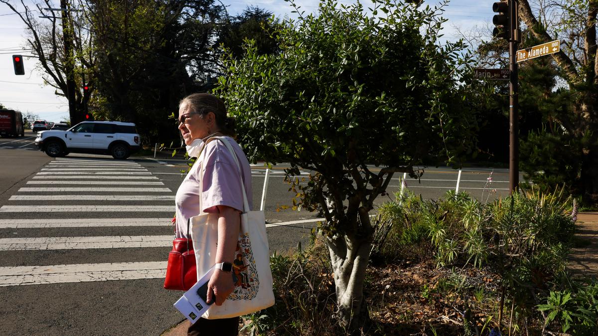 Melissa Quilter, 66, looks at the wide intersection of The Alameda and Marin Avenue in Berkeley, California, on Friday, March 13, 2026. “I don’t cross this intersection any longer because the cars don’t stop when the pedestrians have the right-of-way,” Quilter said. “I would love to see lights that control the left turns and speed limits to be enforced.” (Ray Chavez/Bay Area News Group/TNS)