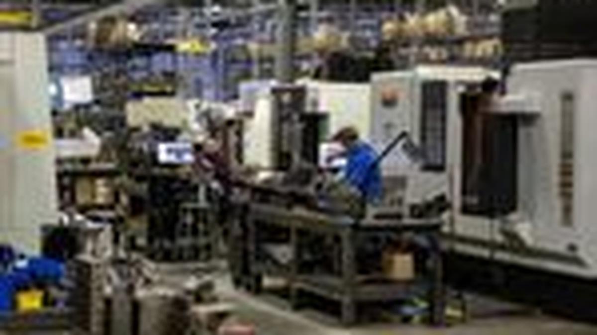FILE PHOTO: Employees work on the production floor of the General Stamping & Metalworks building in South Bend, Indiana, U.S., March 23, 2026. REUTERS/Jim Vondruska/File Photo