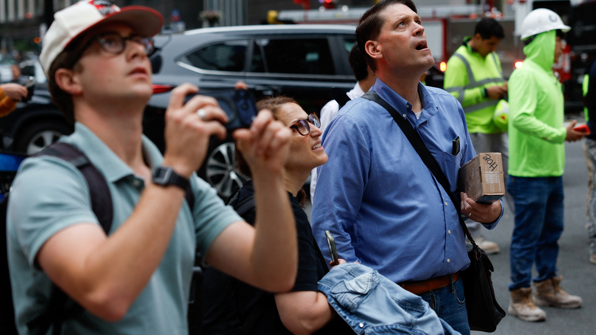 People look up at the site of a building on 42nd Street which was reported to have structural issues in New York City, U.S., July 7, 2026. REUTERS/Jordan Tovin