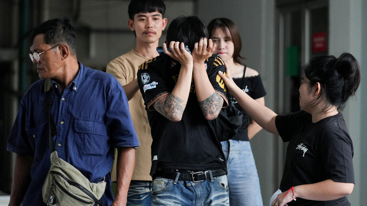 Family members and relatives mourn as they receive the body of a victim at the Police Hospital morgue, following a deadly fire at a pub in Bangkok, Thailand, July 13, 2026. REUTERS/Arnun Chonmahatrakool