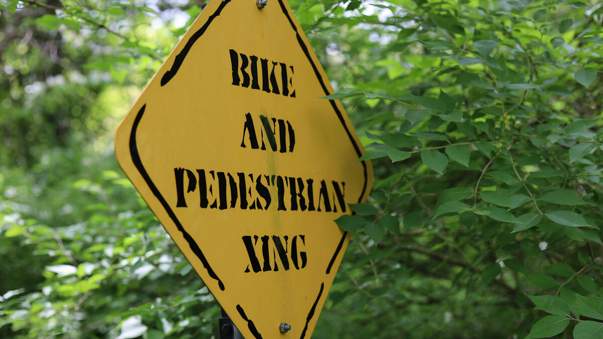 A sign alerts hikers to a bike and pedestrian crossing. (Dreamstime/TNS)