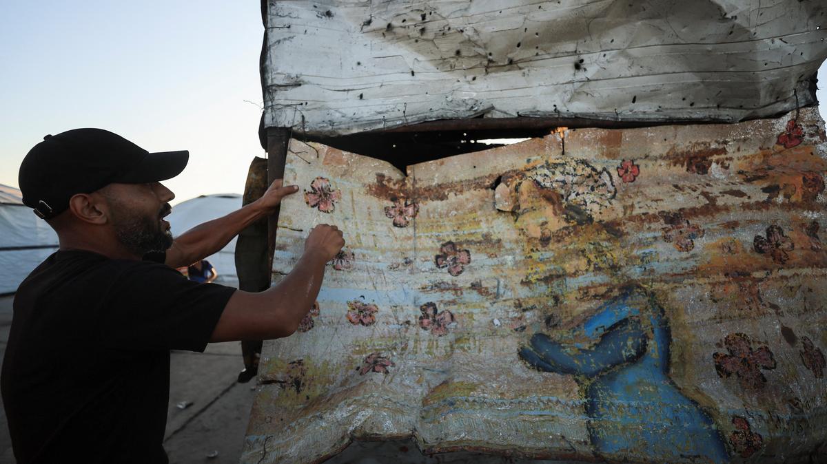 A Palestinian man shows damage at the site of an Israeli strike at a cafe at the seaport of Gaza City May 31, 2026. REUTERS/Dawoud Abu Alkas
