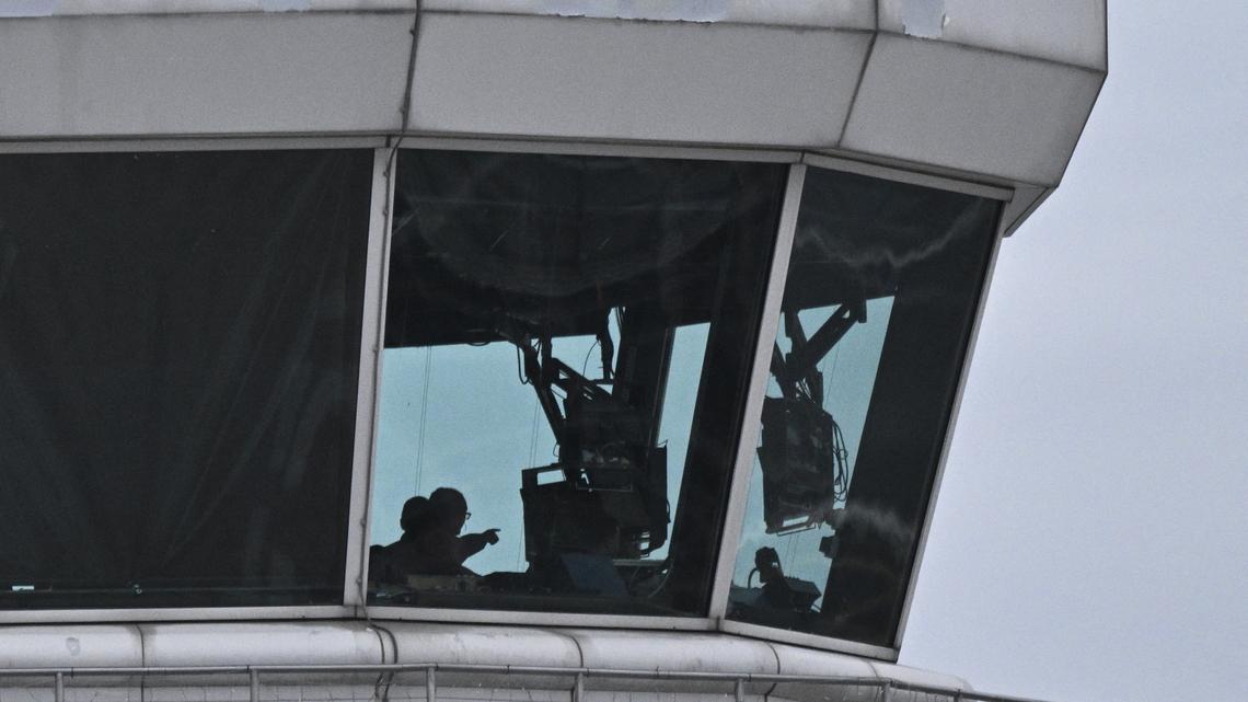 Air controllers work in the control tower of Ronald Reagan International Airport as recovery efforts by authorities for the remains of a commercial liner and a military helicopter that crashed earlier in the week continue on the nearby Potomac River in Arlington, Virginia, on Feb. 2, 2025. (Roberto Schmidt/AFP/Getty Images/TNS)