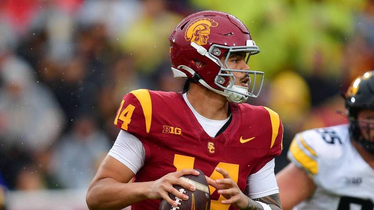  Nov 15, 2025; Los Angeles, California, USA; Southern California Trojans quarterback Jayden Maiava (14) moves out to pass against the Iowa Hawkeyes during the first half at the Los Angeles Memorial Coliseum. Mandatory Credit: Gary A. Vasquez-Imagn Images | Gary A. Vasquez-Imagn Images 