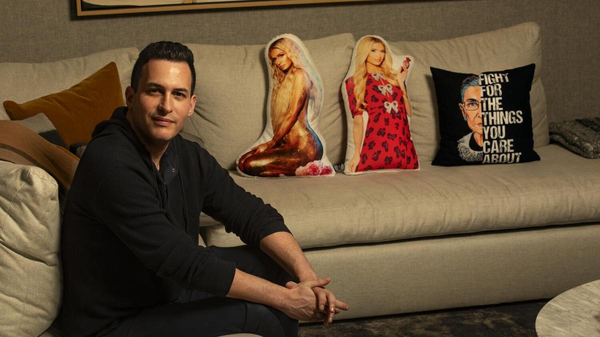 BEVERLY HILLS, CA-JANUARY 12,2024:Alex Baskin, the executive producer of "Vanderpump Rules," is photographed next to pillows with the likeness of socialite Paris Hilton and former associate justice of the Supreme Court, the late Ruth Bader Ginsburg, at his home in Beverly Hills. The television series returns for its 11th season. (Mel Melcon / Los Angeles Times)