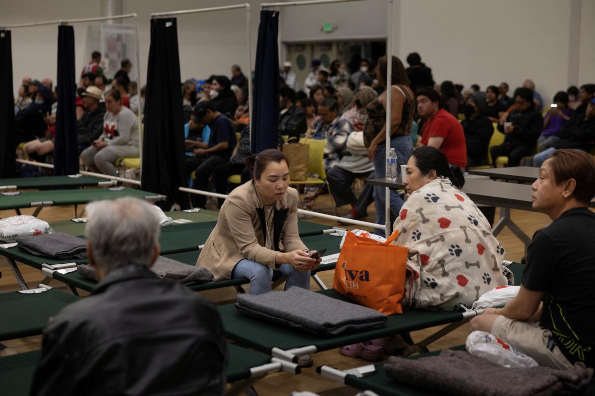 Residents sit at a temporary shelter in Fountain Valley, California, following evacuations prompted by a failing chemical tank containing methyl methacrylate, a flammable liquid used in the aerospace industry, in nearby Garden Grove, California, U.S., May 22, 2026. REUTERS/Ed Ou