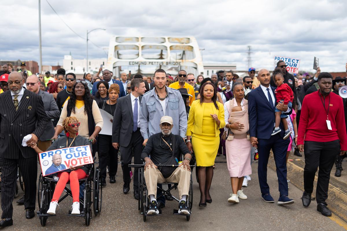 FILE -- Civil rights activists march on Sunday, March 8, 2026, across the Edmund Pettus Bridge in Selma, Ala., to mark the anniversary of Bloody Sunday, a violent episode in which civil rights protesters were attacked 61 years ago. Veterans of the civil rights movement and others said the Supreme Court decision felt like a bleak end to decades of gains in Black representation in the region. (Rita Harper/The New York Times)