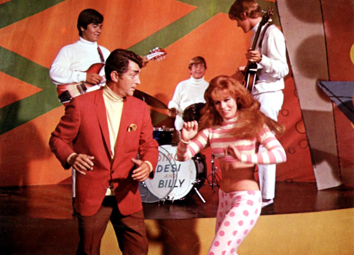 Dean Martin and Ann-Margret dance while Dino, Desi & Billy perform in Murderers’ Row (1966)Everett Collection