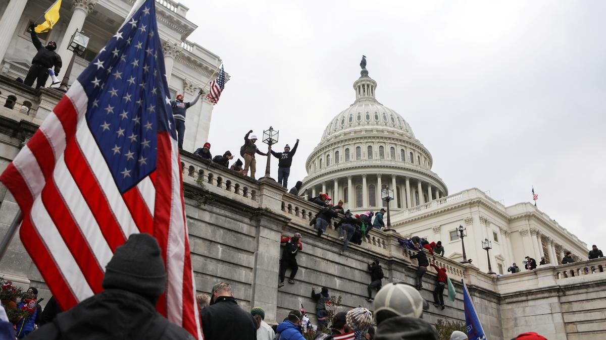 Supporters of U.S. President Donald Trump climb on walls at the U.S. Capitol during a protest against the certification of the 2020 U.S. presidential election results by the U.S. Congress, in Washington, U.S., January 6, 2021. REUTERS/Jim Urquhart/File Photo