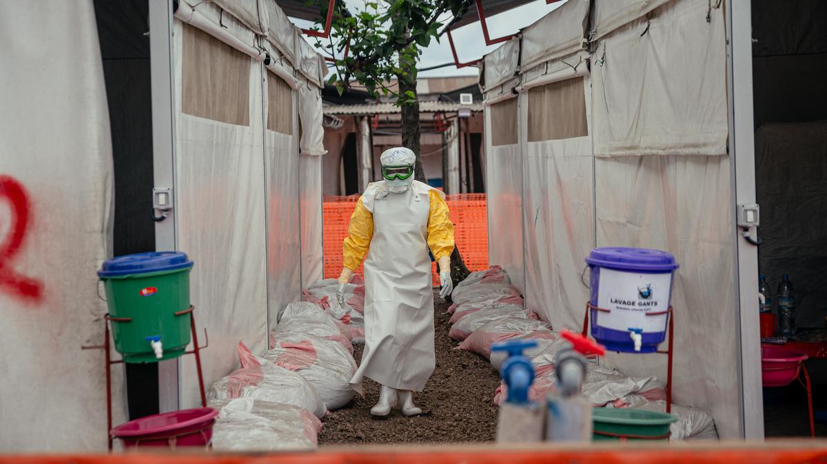 A Doctors Without Borders (MSF) doctor wearing personal protective equipment moves through the isolated red zone to monitor patients, provide medical care, and ensure sanitation of the facility at the Ebola Treatment Center in Munigi on Tuesday, June 2, 2026. The sole airport providing humanitarian organizations access to the epicenter of an Ebola outbreak in the Democratic Republic of Congo reopened on June 2 when the reported number of suspected cases declined. (Jospin Mwisha/AFP/Getty Images/TNS)