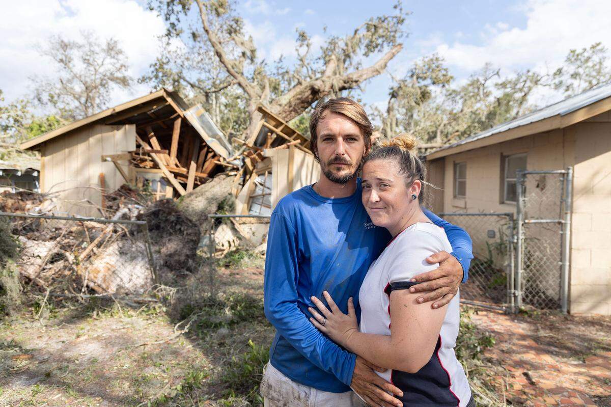 Charles Webb and his wife Dana Webb in front of their rental home in which a tree came crashing down during Hurricane Helene in Steinhatchee, Florida, on Friday.
