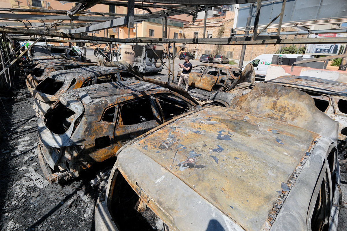 Burned vehicles stand at a depot of Italian car rental company Sicily by Car after an arson attack, in the San Lorenzo district of Palermo, Sicily, Italy, June 11, 2026. REUTERS/Igor Petyx