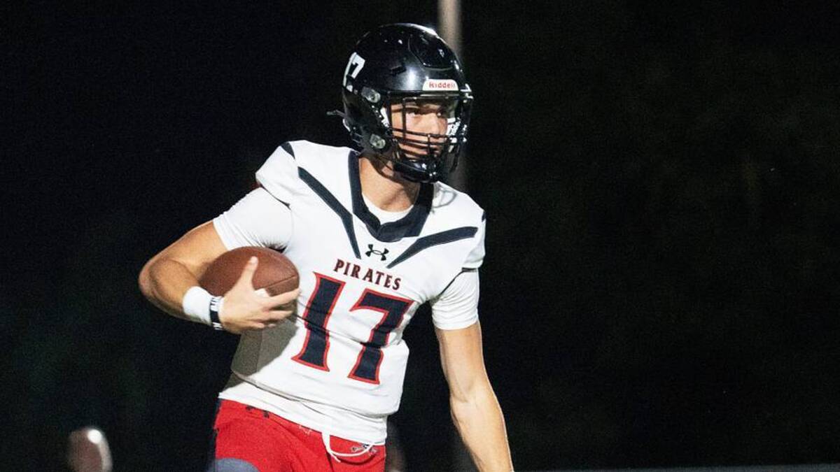  Logan Flaherty, the quarterback of Port Charlotte eludes a Dunbar defender during a game at Dunbar on Friday, Oct. 10, 2025. Port Charlotte won. | USA TODAY Network via Reuters Connect 
