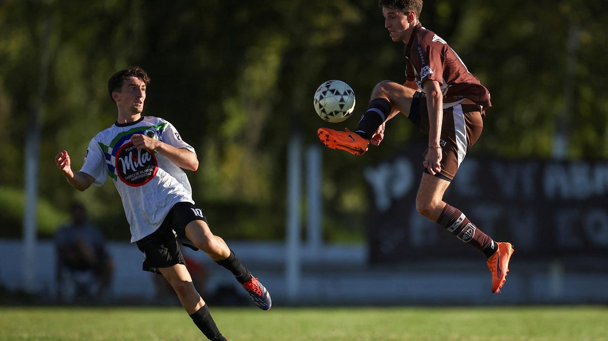 Salvador Caligo (right), a player from San Miguel de Las Heras, and a player from the opposing team EFIC Canuelas, fight for the ball during a soccer match, as part of the regional semi-amateur Liga de Lobos tournament, where some players are paid per game, in General Las Heras, Buenos Aires province, Argentina, April 12, 2026. For three-time World Cup champions Argentina, football is a feverish passion that permeates every home. REUTERS/Agustin Marcarian