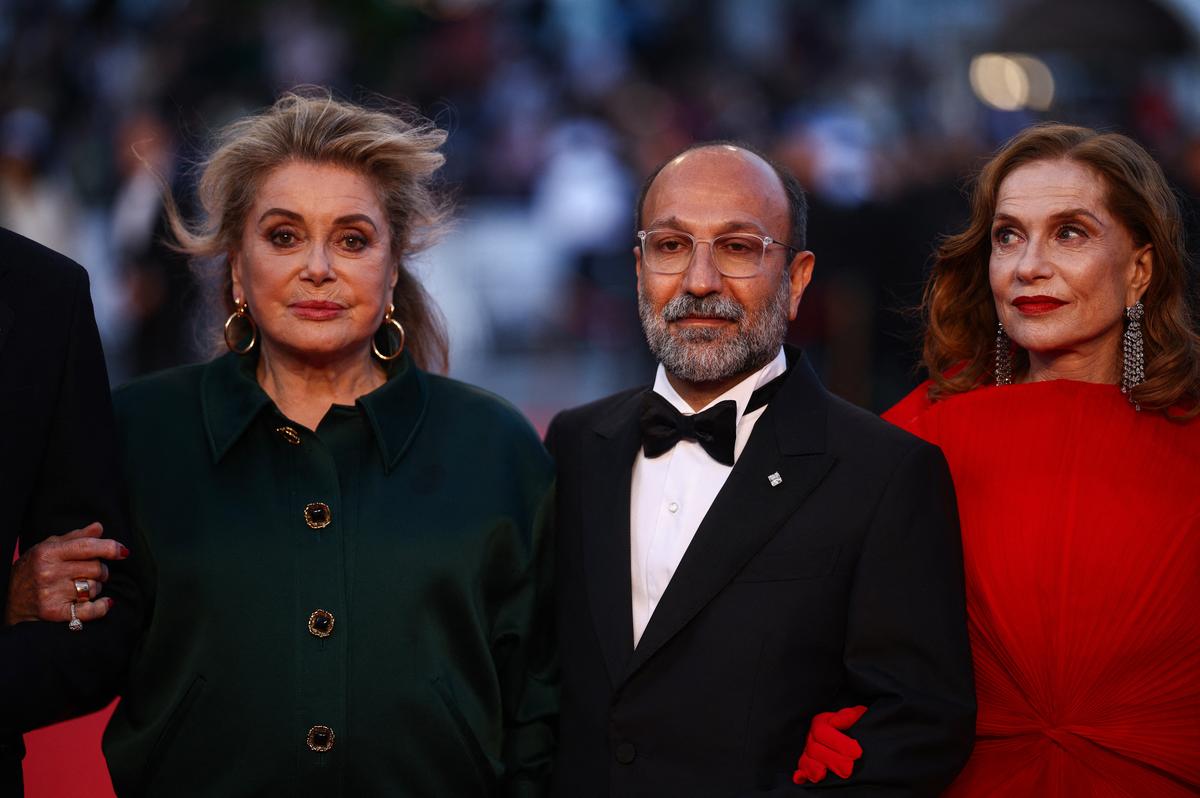 Director Asghar Farhadi and cast members Isabelle Huppert and Catherine Deneuve pose on the red carpet during arrivals for the screening of the film "Histoires paralleles" (Parallel Tales) in competition at the 79th Cannes Film Festival in Cannes, France, May 14, 2026. REUTERS/Marko Djurica
