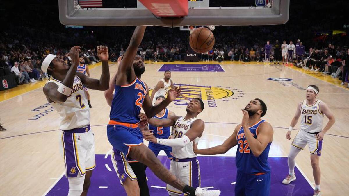  Mar 8, 2026; Los Angeles, California, USA; New York Knicks center Mitchell Robinson (23) dunks the ball against Los Angeles Lakers forward Jarred Vanderbilt (2) and forward Rui Hachimura (28) in the first half at Crypto.com Arena. Mandatory Credit: Kirby Lee-Imagn Images | Kirby Lee-Imagn Images 