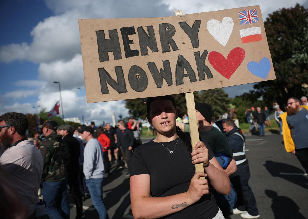 A demonstrator holds a placard outside Southampton Central Police Station following the conviction of Vikrum Digwa for the murder of student Henry Nowak, in Southampton, Britain, June 2, 2026. REUTERS/Isabel Infantes