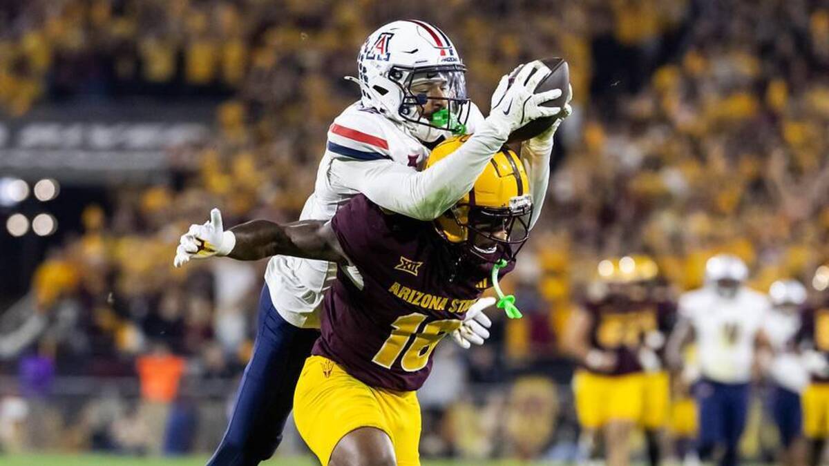  Nov 28, 2025; Tempe, Arizona, USA; Arizona Wildcats defensive back Treydan Stukes (2) intercepts the ball against Arizona State Sun Devils wide receiver Jaren Hamilton (16) in the second half during the 99th Territorial Cup at Mountain America Stadium. Mandatory Credit: Mark J. Rebilas-Imagn Images | Mark J. Rebilas-Imagn Images 