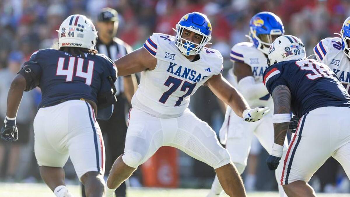  Nov 8, 2025; Tucson, Arizona, USA; Kansas Jayhawks offensive lineman Enrique Cruz Jr. (77) against the Arizona Wildcats at Arizona Stadium. Mandatory Credit: Mark J. Rebilas-Imagn Images | Mark J. Rebilas-Imagn Images 