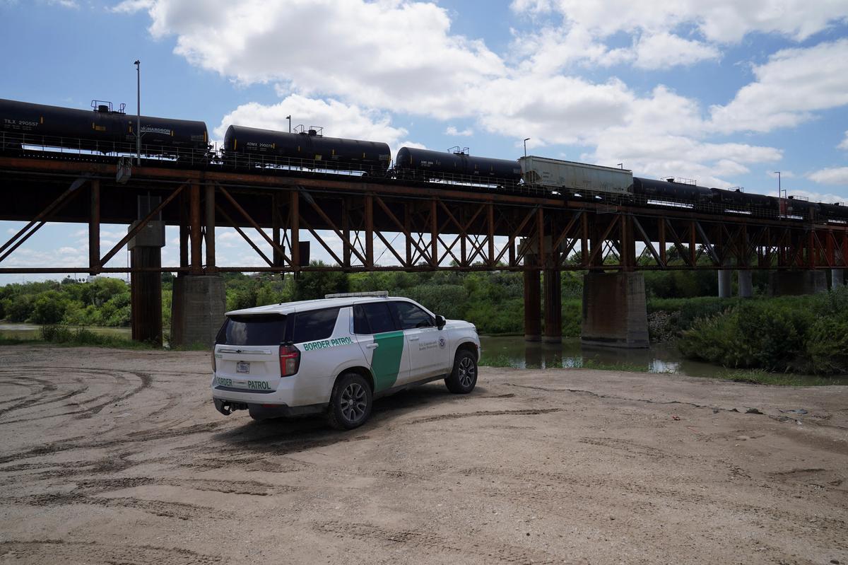 Border Patrol agents oversee the Rio Grande after six bodies were found on Sunday in a train boxcar, in Laredo, Texas, U.S. May 11, 2026.  REUTERS/Gabriel V. Cardenas