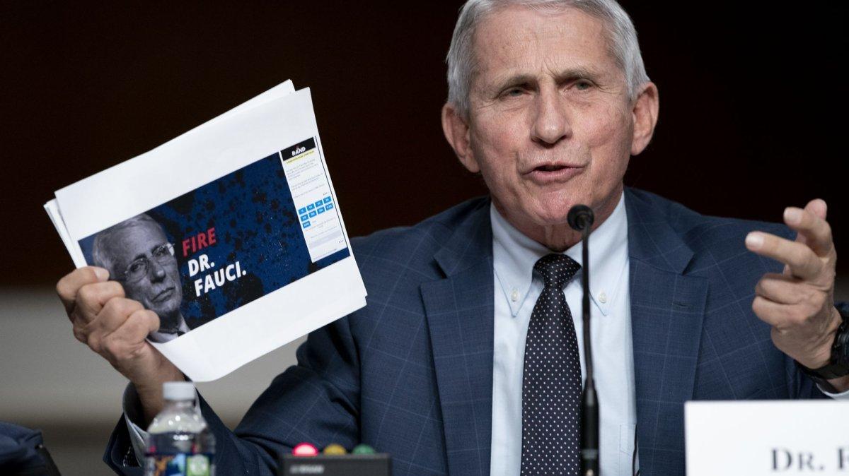 Dr. Anthony Fauci, then-director of the National Institute of Allergy and Infectious Diseases, testifies before a Senate committee hearing in 2022 in Washington. One of Fauci's former aides has been charged with concealing emails, the Justice Department said Tuesday. Fauci is not implicated in the case.
