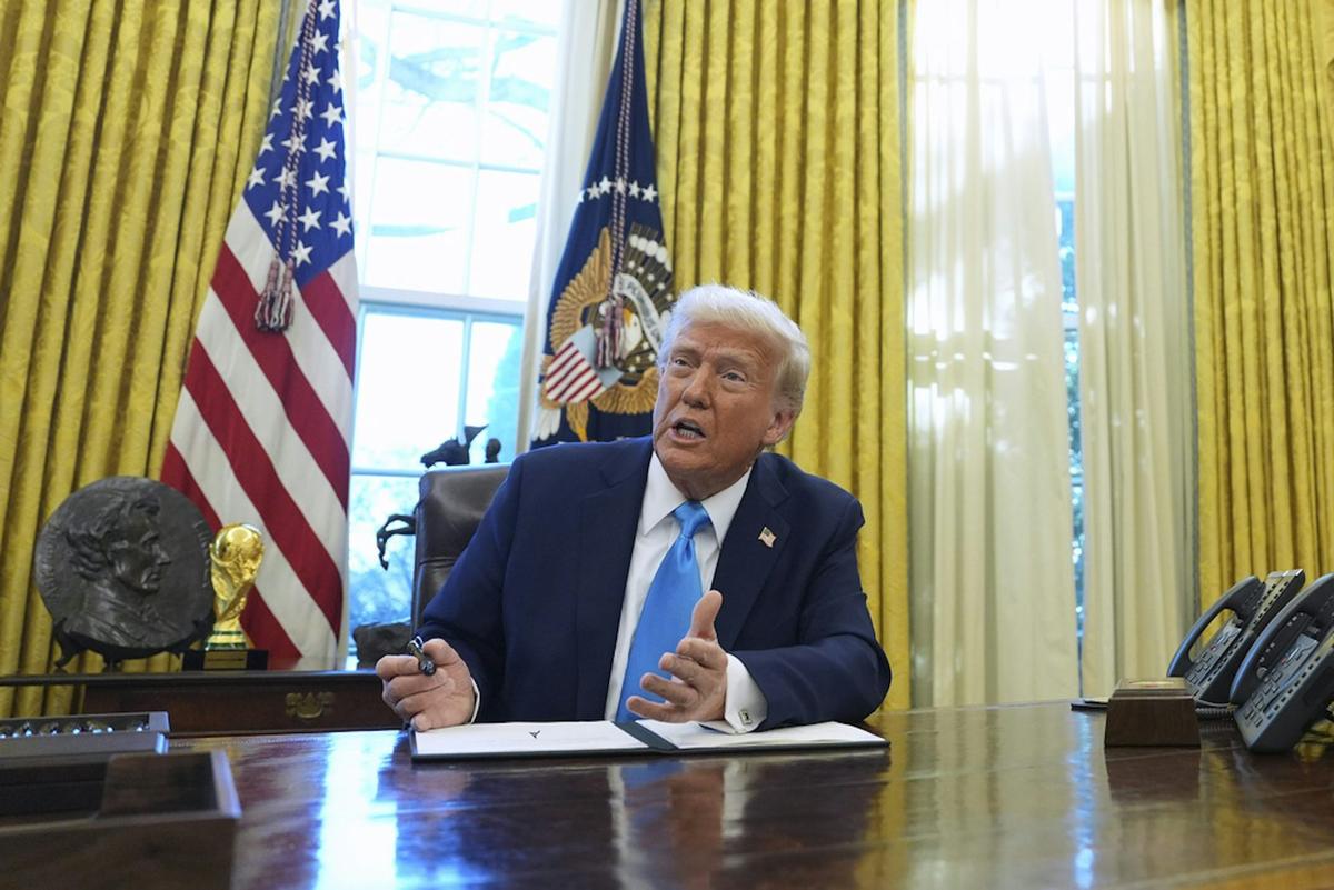  President Donald Trump speaks to reporters as he signs executive orders in the White House. AP Photo/Evan Vucci 