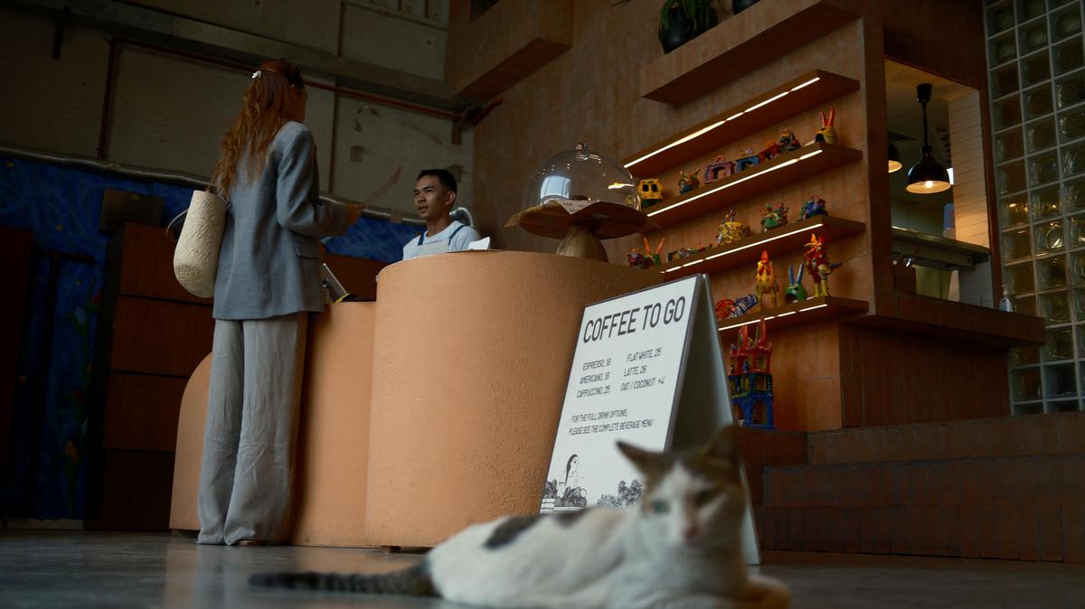 A cat sits while a cashier tends to a customer at Lila Molino restaurant in Dubai, United Arab Emirates, April 28, 2026. REUTERS