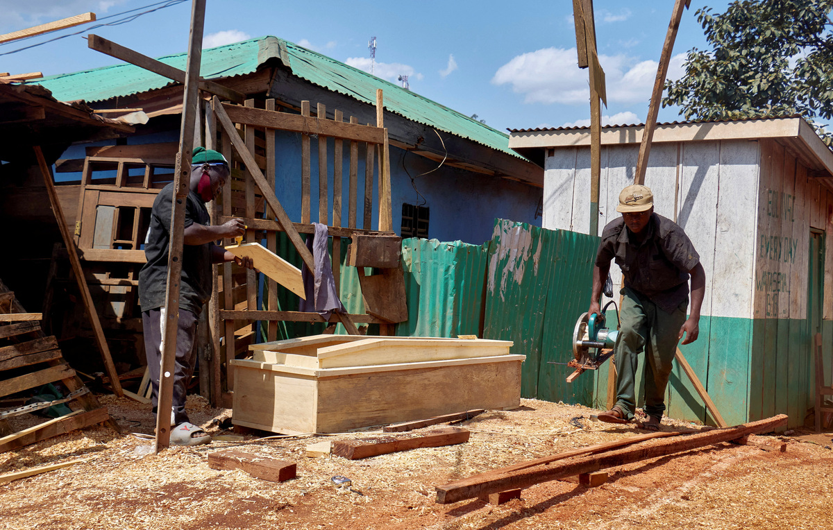 Congolese carpenters Moise and Patrick, assemble a coffin due to high demand following Ebola suspected deaths, as aid agencies intensify efforts to contain a new Ebola outbreak involving the Bundibugyo strain, in Mongbwalu, Djugu Territory of Ituri province, Democratic Republic of the Congo, June 4, 2026. REUTERS/Gradel Muyisa Mumbere