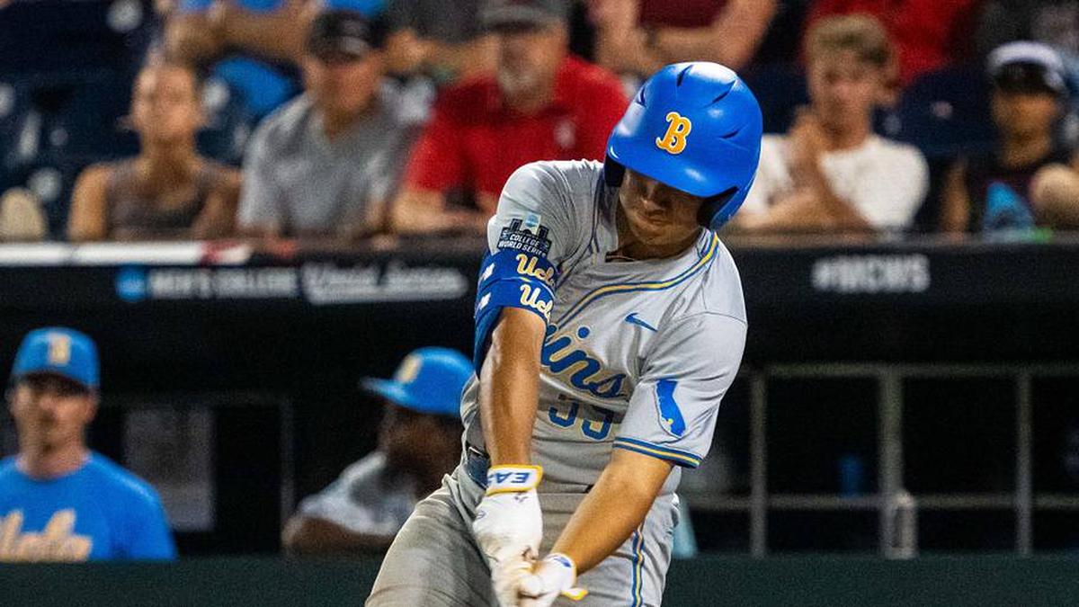  Jun 17, 2025; Omaha, Neb, USA; UCLA Bruins first baseman Mulivai Levu (39) hits a triple against the Arkansas Razorbacks during the ninth inning at Charles Schwab Field. Mandatory Credit: Dylan Widger-Imagn Images | Dylan Widger-Imagn Images 