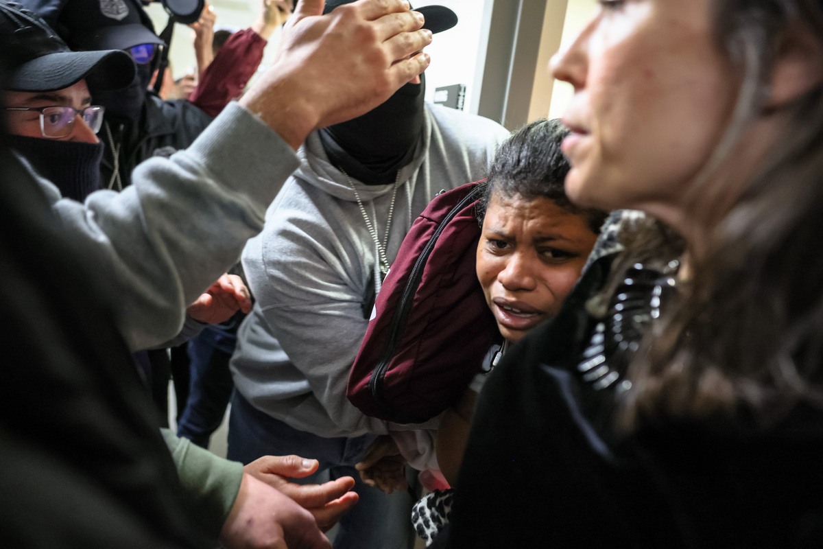  Federal agents detain a woman leaving a court hearing in immigration court at the Jacob K. Javits Federal Building on March 04, 2026 in New York City. 