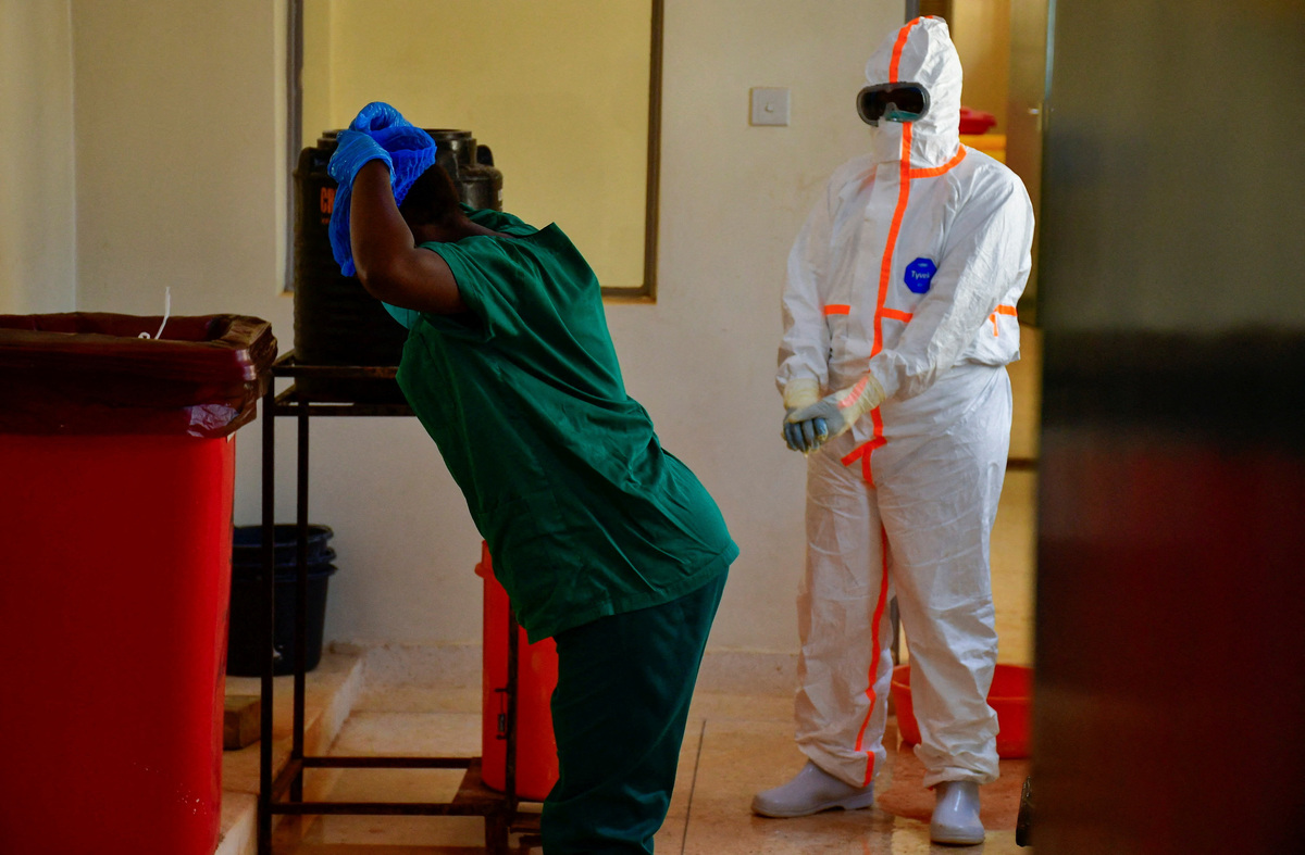 Ugandan medical doctors remove their personal protective equipment (PPE) during a visit by the Director-General of the World Health Organisation (WHO) Tedros Adhanom Ghebreyesus at the Mulago National Referral Hospital Isolation Unit, as aid agencies intensify efforts to contain a new Ebola outbreak involving the Bundibugyo Virus, in Mulago suburb, of Kampala, Uganda June 8, 2026. REUTERS/ Abubaker Lubowa
